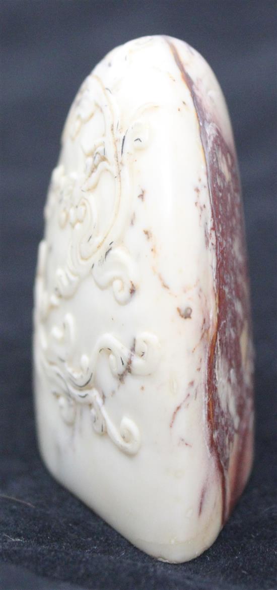 A Chinese cream and red soapstone seal, 6.3cm